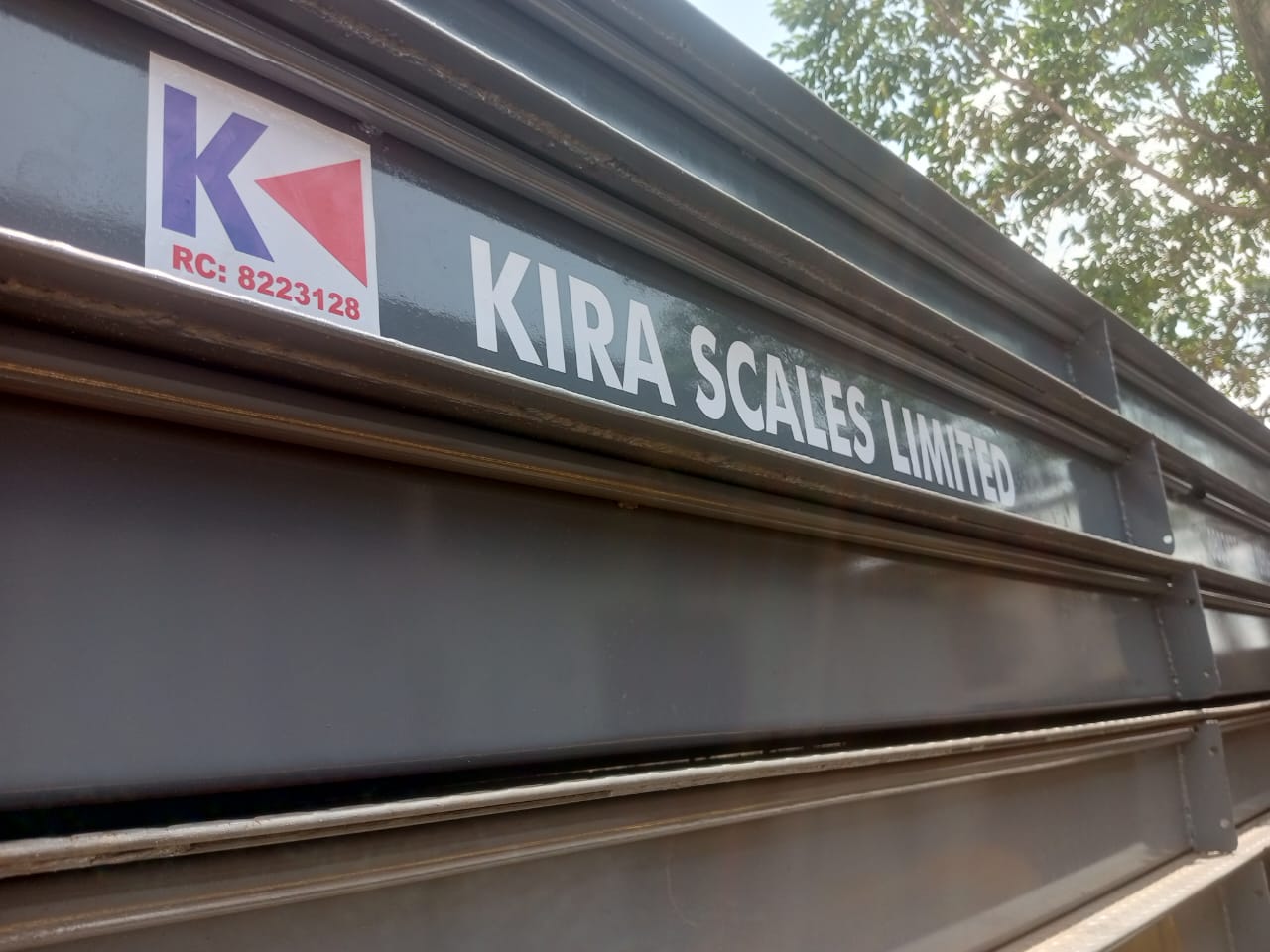 Kira Scales Limited branding on stacked weighbridge steel decks
