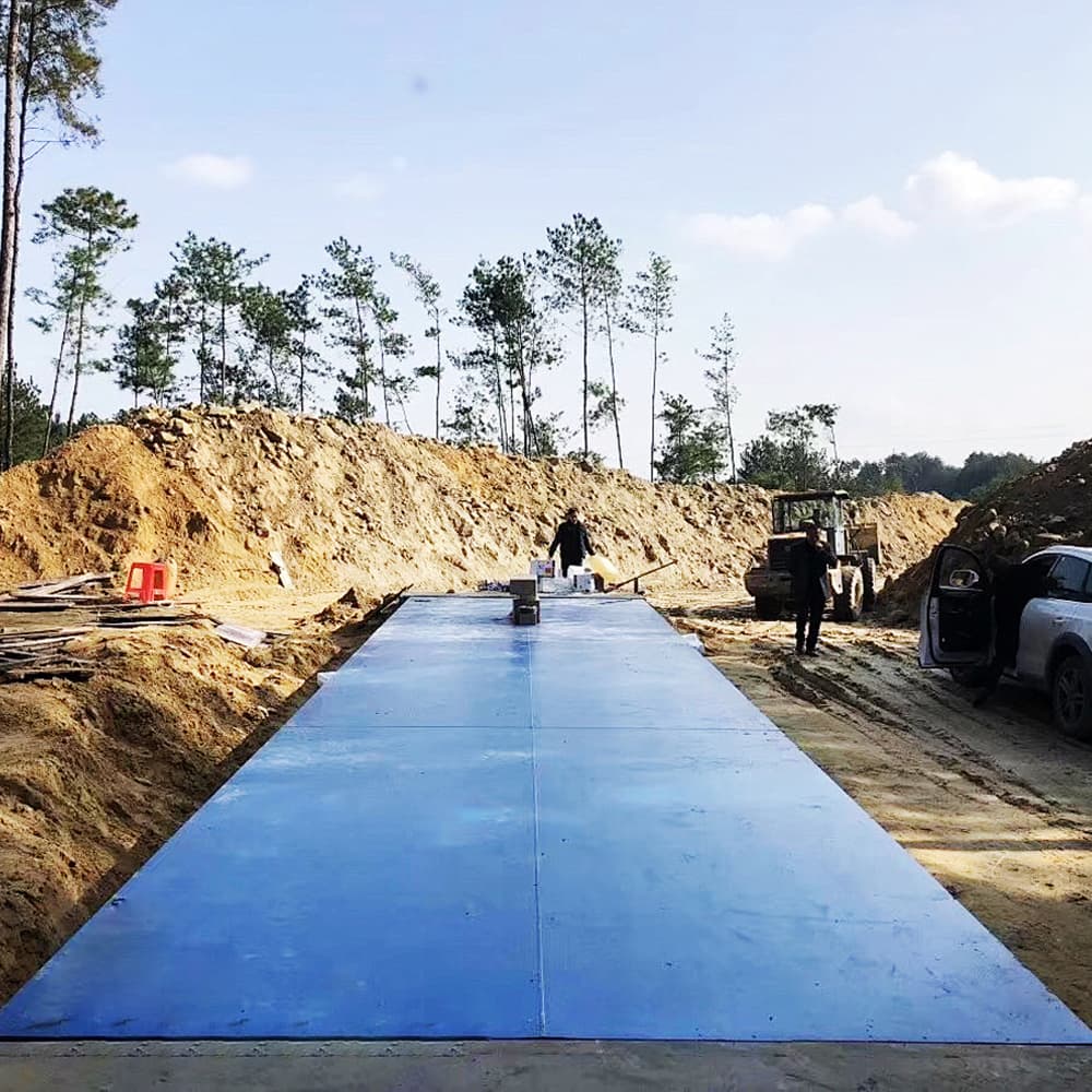 Blue weighbridge platform at a construction site